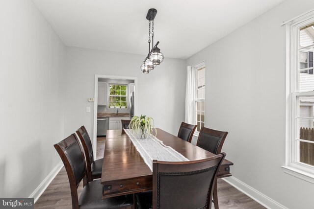 dining room with dark wood-style flooring and baseboards