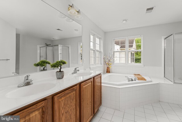 full bathroom with a bath, a shower stall, tile patterned flooring, and double vanity