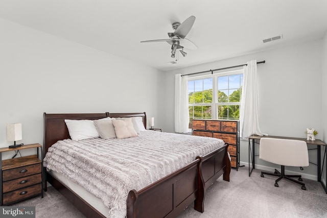 bedroom with light colored carpet, baseboards, and a ceiling fan