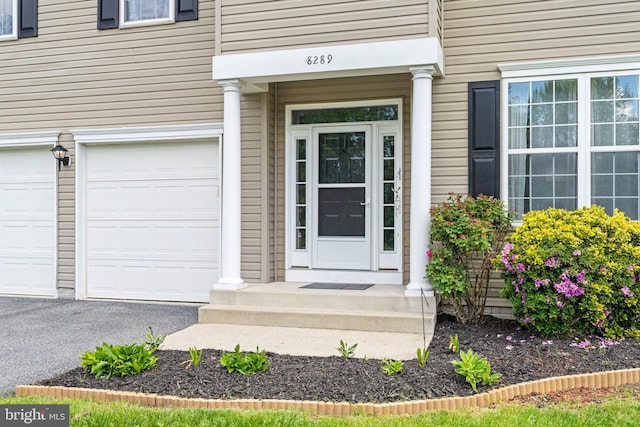 entrance to property with a garage and driveway