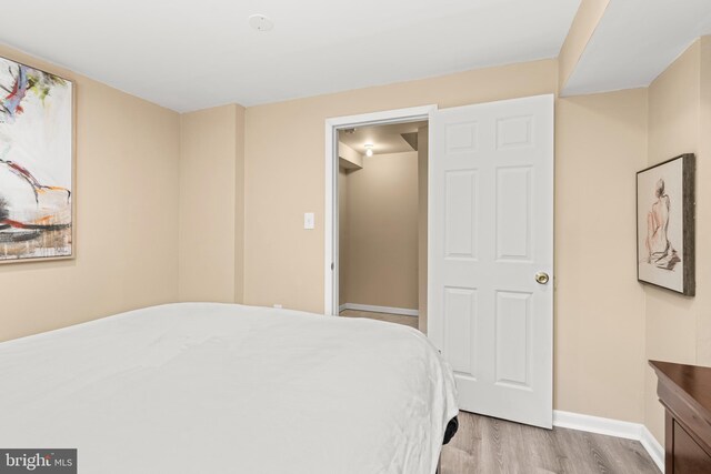 bedroom with baseboards and light wood-type flooring