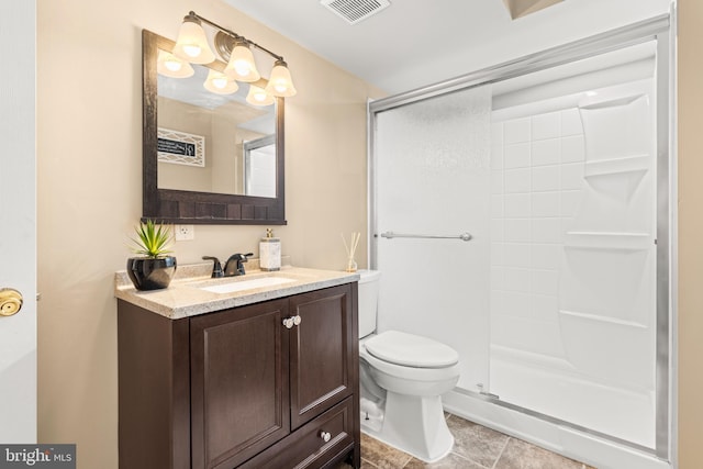 full bathroom featuring toilet, a shower stall, vanity, and tile patterned flooring