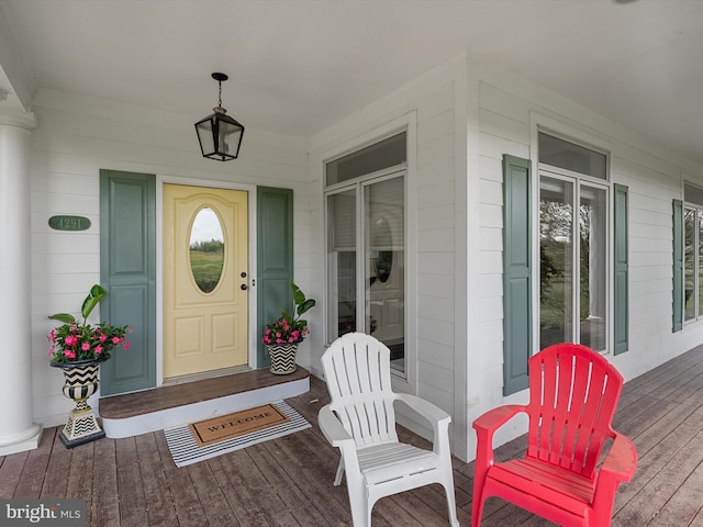 view of exterior entry featuring a porch