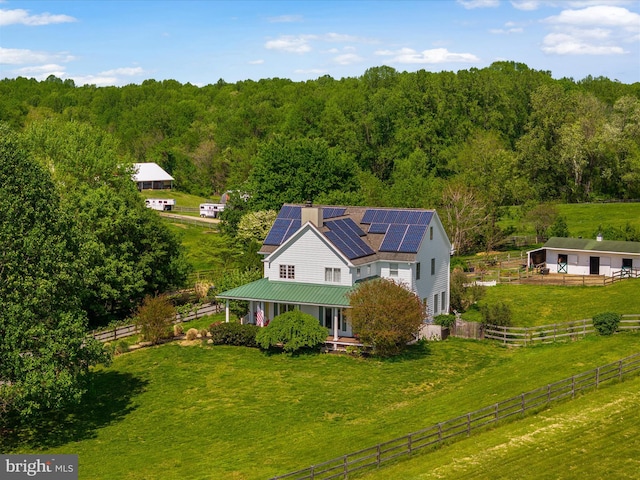 birds eye view of property featuring a view of trees