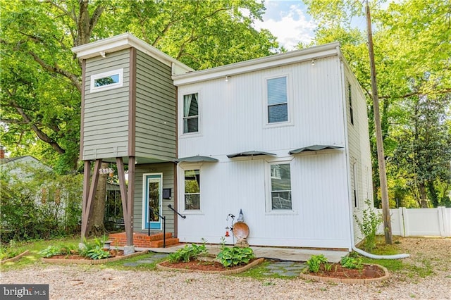 back of house featuring fence