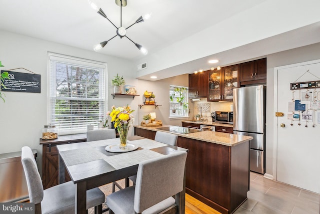 dining space with visible vents and an inviting chandelier