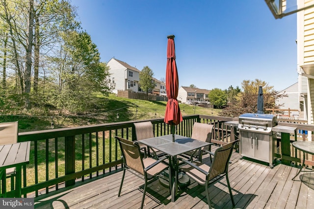 wooden deck featuring a residential view and outdoor dining space