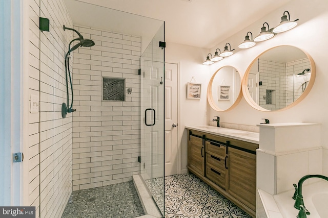 bathroom with a tub to relax in, a shower stall, tile patterned flooring, double vanity, and a sink