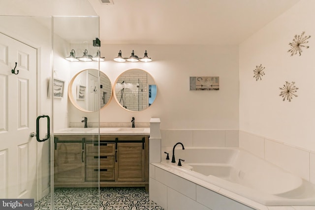 bathroom with double vanity, a garden tub, tile patterned floors, and a sink