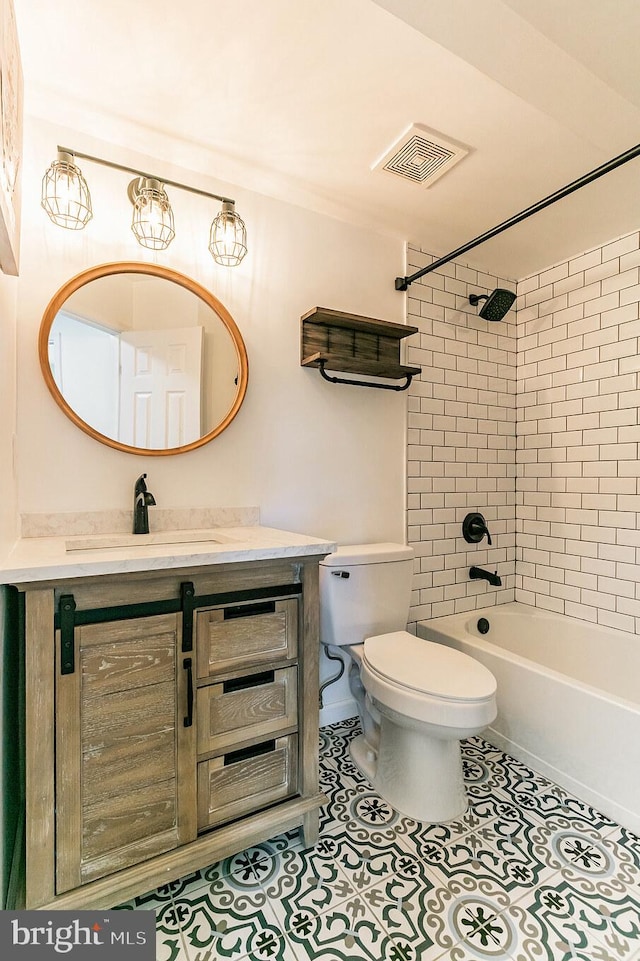 full bathroom featuring tile patterned floors, toilet, visible vents, vanity, and shower / tub combination