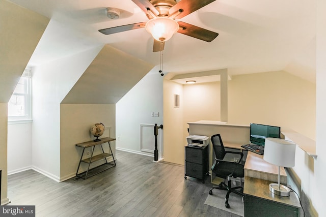 office area featuring vaulted ceiling, wood finished floors, visible vents, a ceiling fan, and baseboards