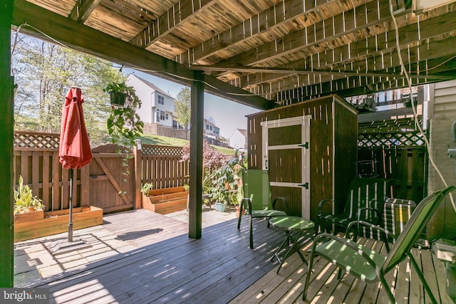 wooden deck with a gate and fence