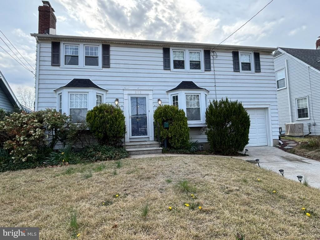 203 Harding Ave, Westmont, NJ 08108 - colonial inspired home featuring a chimney, central air condition unit, a front yard, entry steps, and a garage