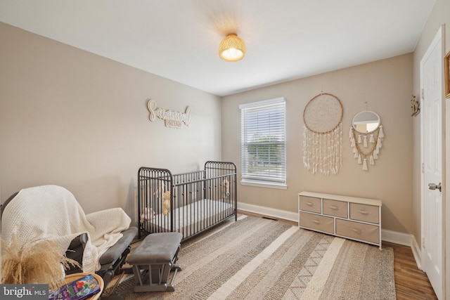 12527 Misty Water Dr, Herndon, VA 20170 - bedroom featuring baseboards, visible vents, and wood finished floors