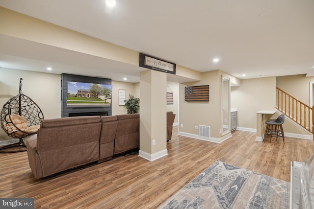 12527 Misty Water Dr, Herndon, VA 20170 - living area with recessed lighting, stairway, light wood-style floors, visible vents, and baseboards