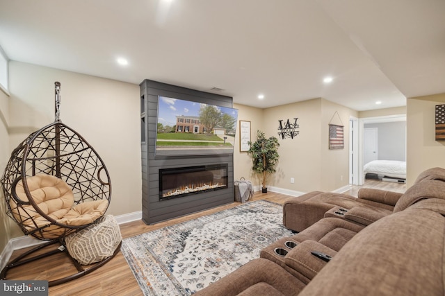 12527 Misty Water Dr, Herndon, VA 20170 - living room with a glass covered fireplace, wood finished floors, and baseboards