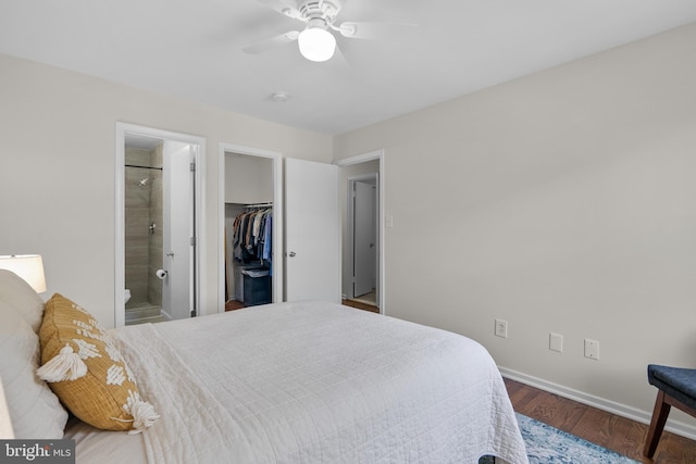 bedroom featuring wood finished floors, a closet, baseboards, a spacious closet, and a ceiling fan