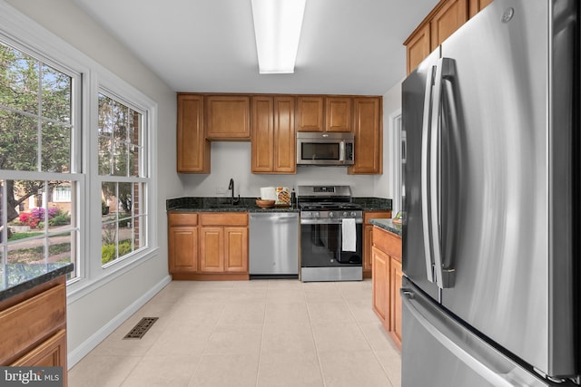 kitchen with visible vents, brown cabinets, and stainless steel appliances