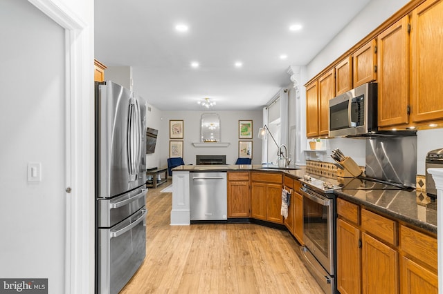 25 Blueberry Run, Southampton, NJ 08088 - kitchen featuring brown cabinets, stainless steel appliances, a sink, light wood-type flooring, and a peninsula