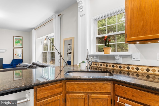 25 Blueberry Run, Southampton, NJ 08088 - kitchen with stainless steel dishwasher, a sink, dark stone counters, open floor plan, and brown cabinetry