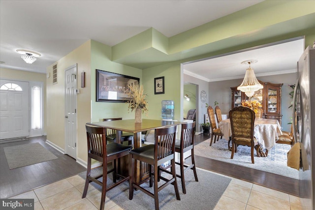 dining room with baseboards, an inviting chandelier, and light tile patterned flooring