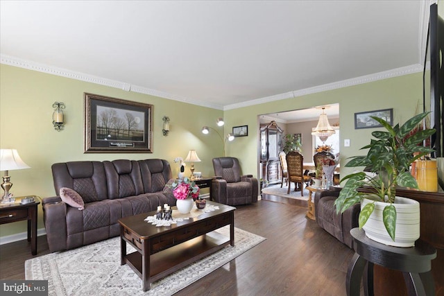 living area with a chandelier, wood finished floors, and ornamental molding