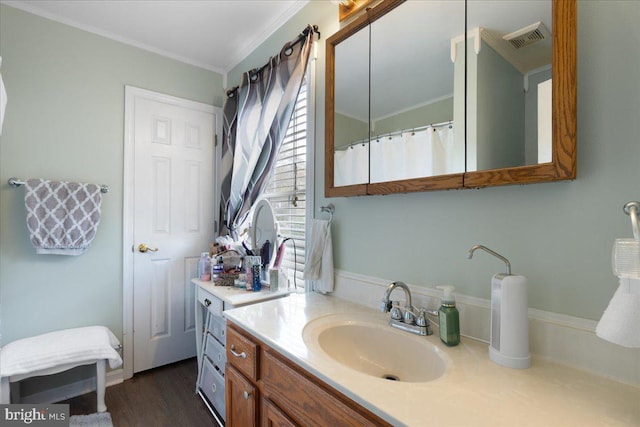 full bathroom with ornamental molding, visible vents, vanity, and wood finished floors