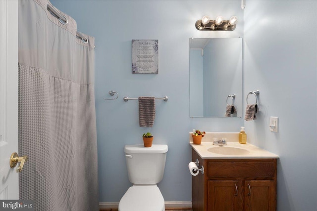 full bathroom with toilet, vanity, and a shower with curtain