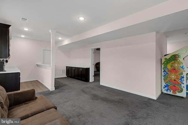 carpeted living area with visible vents, baseboards, and recessed lighting