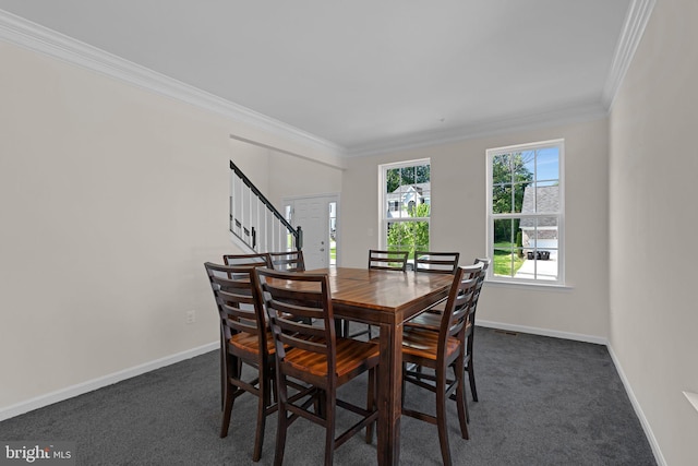 dining room featuring ornamental molding, stairs, baseboards, and dark carpet