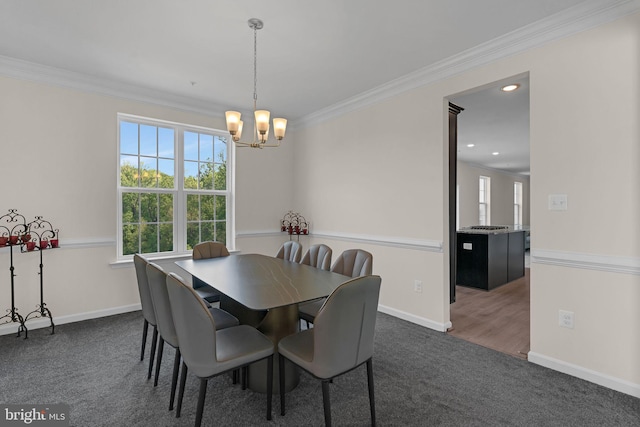 dining area featuring carpet flooring, an inviting chandelier, baseboards, and crown molding