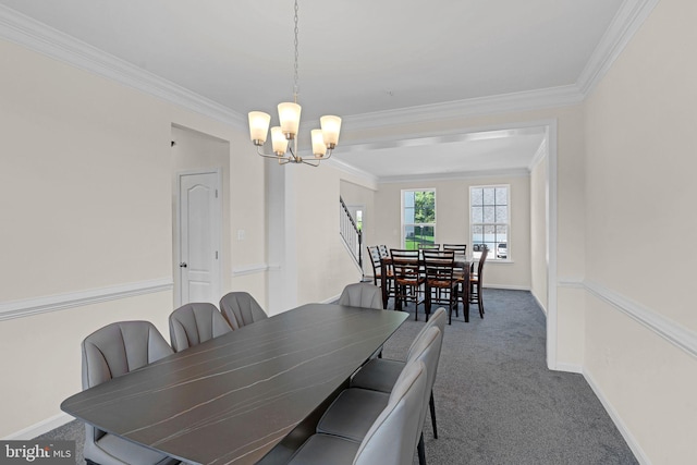 dining room with crown molding, baseboards, carpet floors, and a notable chandelier