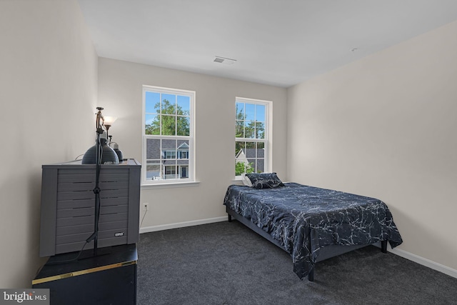 bedroom with carpet flooring, baseboards, and visible vents