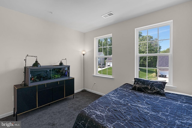 bedroom with baseboards, carpet flooring, and visible vents