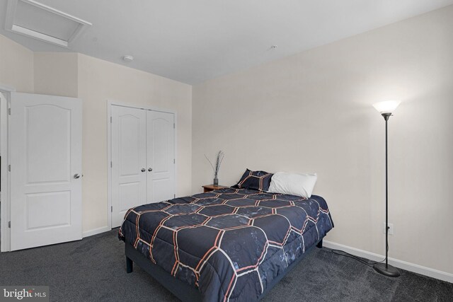 carpeted bedroom with attic access, a closet, and baseboards