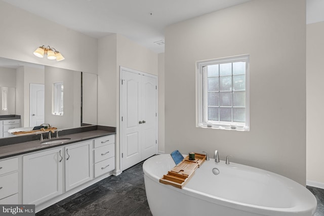 bathroom with vanity and a soaking tub