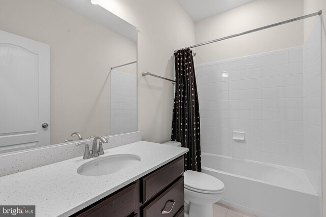 bathroom with toilet, tile patterned flooring, vanity, and shower / bath combo with shower curtain