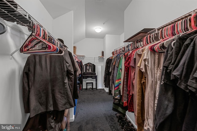 spacious closet featuring carpet flooring and vaulted ceiling