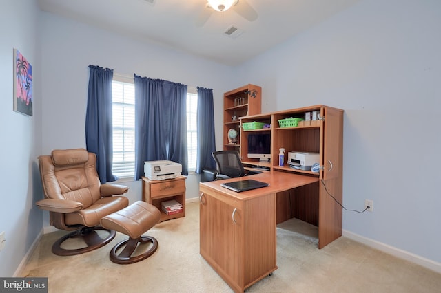 home office featuring baseboards, light carpet, and a ceiling fan