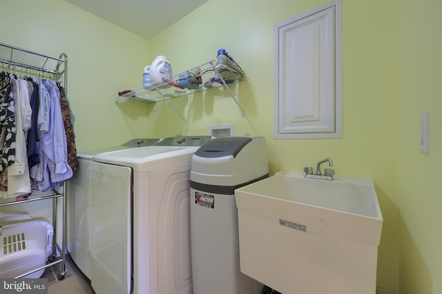 washroom with a sink, independent washer and dryer, and laundry area