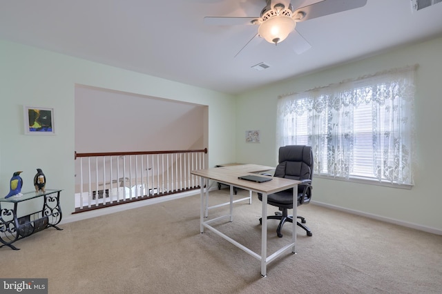 carpeted home office with baseboards, visible vents, and ceiling fan