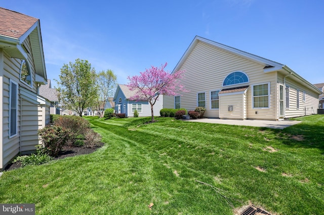 rear view of house featuring a patio area and a yard