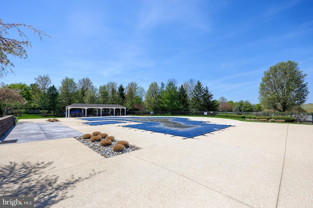 view of swimming pool featuring a fenced in pool, a patio area, and fence