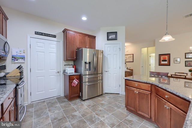 kitchen with recessed lighting, visible vents, light stone counters, hanging light fixtures, and appliances with stainless steel finishes