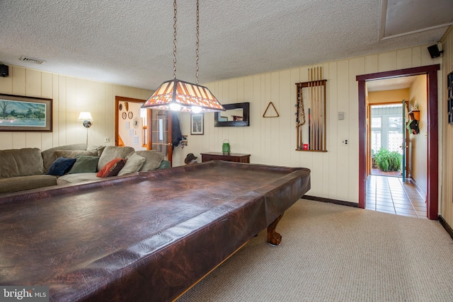 playroom with carpet floors, baseboards, a textured ceiling, and visible vents