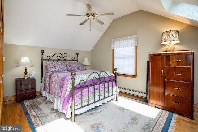 bedroom with ceiling fan, baseboards, wood finished floors, lofted ceiling, and a baseboard heating unit