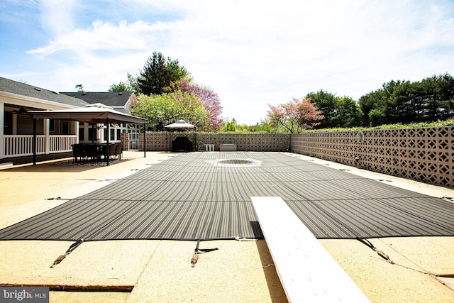 view of swimming pool with outdoor dining area, a fenced backyard, and a patio area