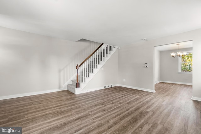 96 Budd Ave, Pemberton, NJ 08068 - unfurnished living room with a notable chandelier, baseboards, stairs, visible vents, and wood finished floors