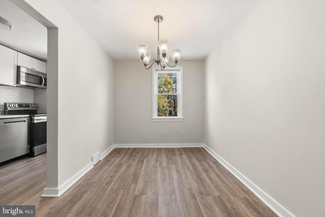 96 Budd Ave, Pemberton, NJ 08068 - unfurnished dining area featuring visible vents, baseboards, an inviting chandelier, and wood finished floors