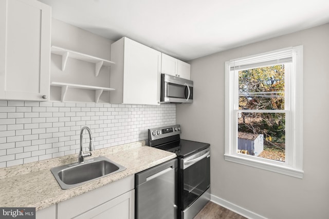 96 Budd Ave, Pemberton, NJ 08068 - kitchen with open shelves, a sink, appliances with stainless steel finishes, white cabinetry, and decorative backsplash